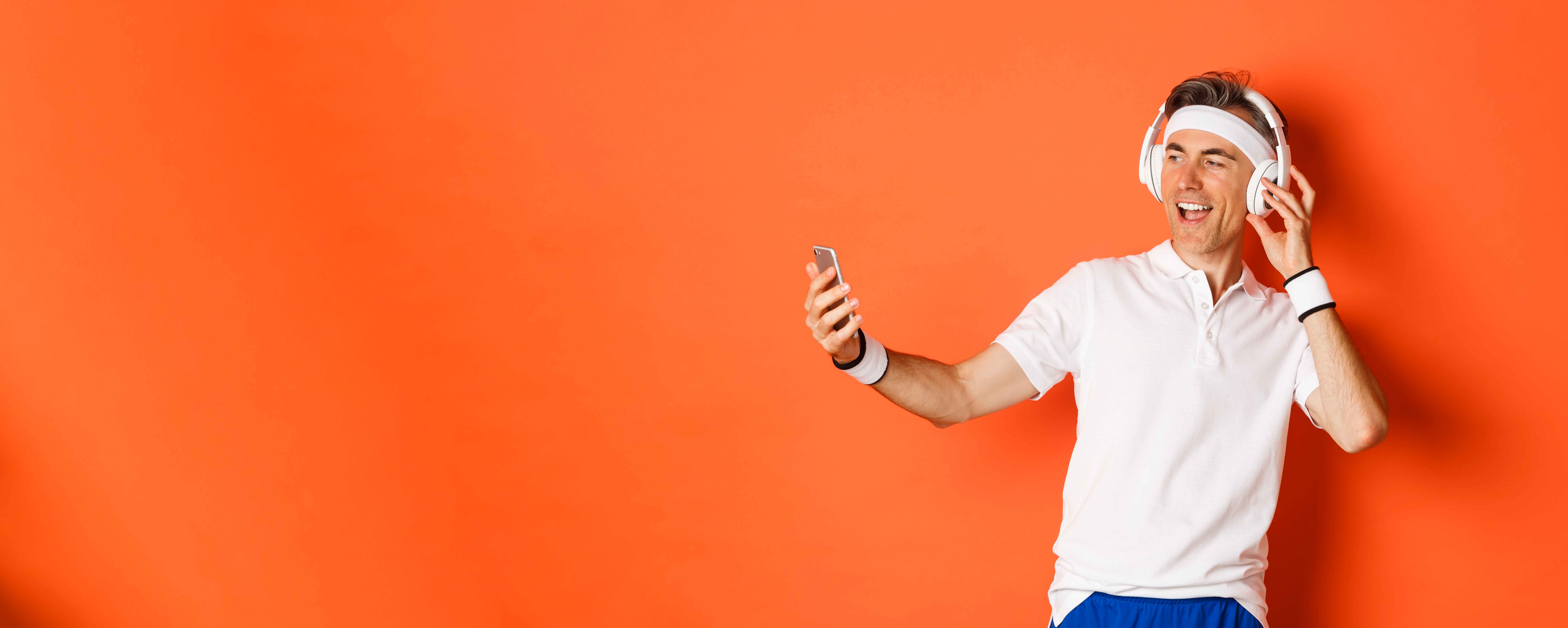 portrait-handsome-middleaged-male-athlete-wearing-gym-uniform-listening-music-headphones-t (1)